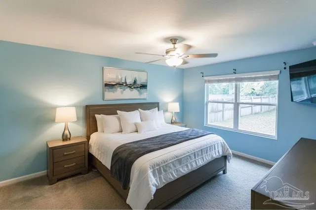 a bedroom with a large bed and a window