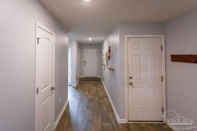 a view of a room with wooden floor and a bathroom