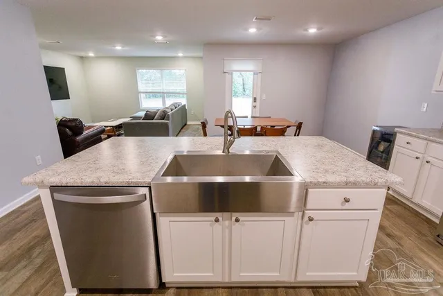 a kitchen with a stove a sink and a refrigerator