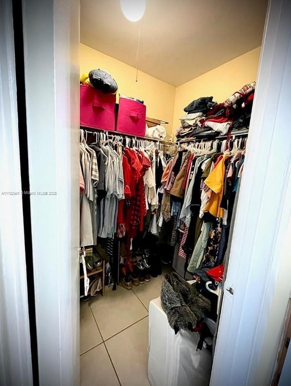 15320 Southwest 106th Terrace, Unit 1108 Miami, FL 33196 - Photo 12 of 19 a view of walk in closet with clothes and shoes