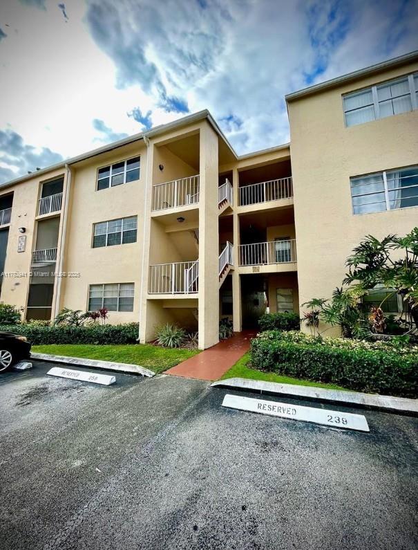 15320 Southwest 106th Terrace, Unit 1108 Miami, FL 33196 - Photo 2 of 19 front view of a house with a yard