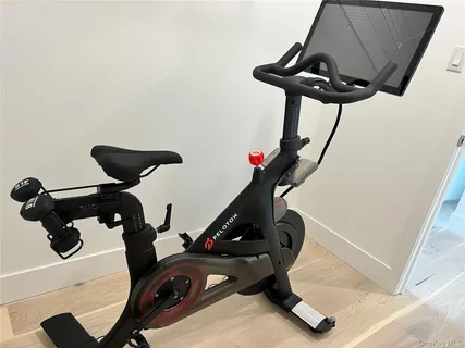 a room with gym equipment and a view of living room