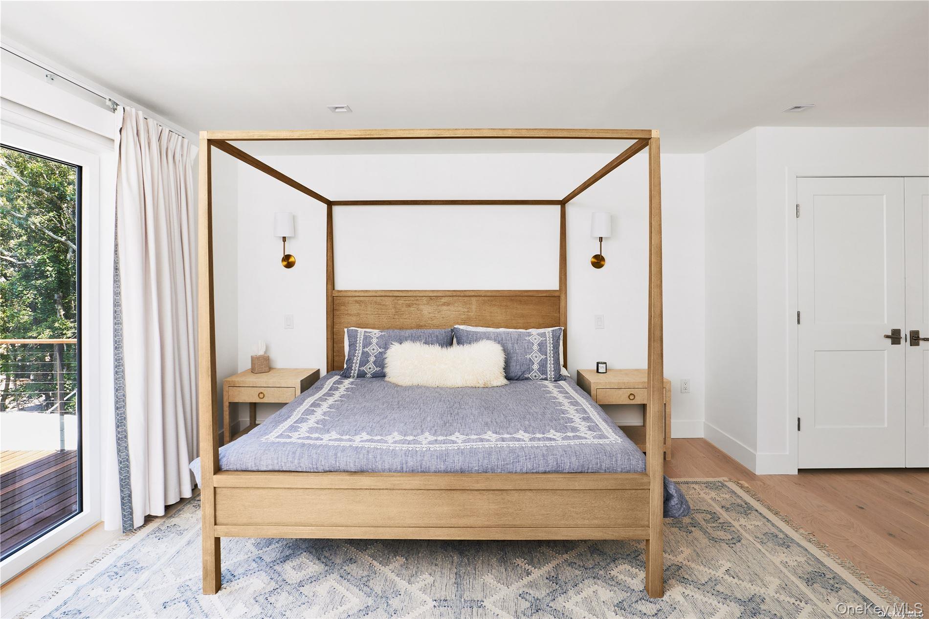 11925 Soundview Avenue Southold, NY 11971 - Photo 9 of 15 Primary bedroom with private deck and water views, 2 walk-in closets