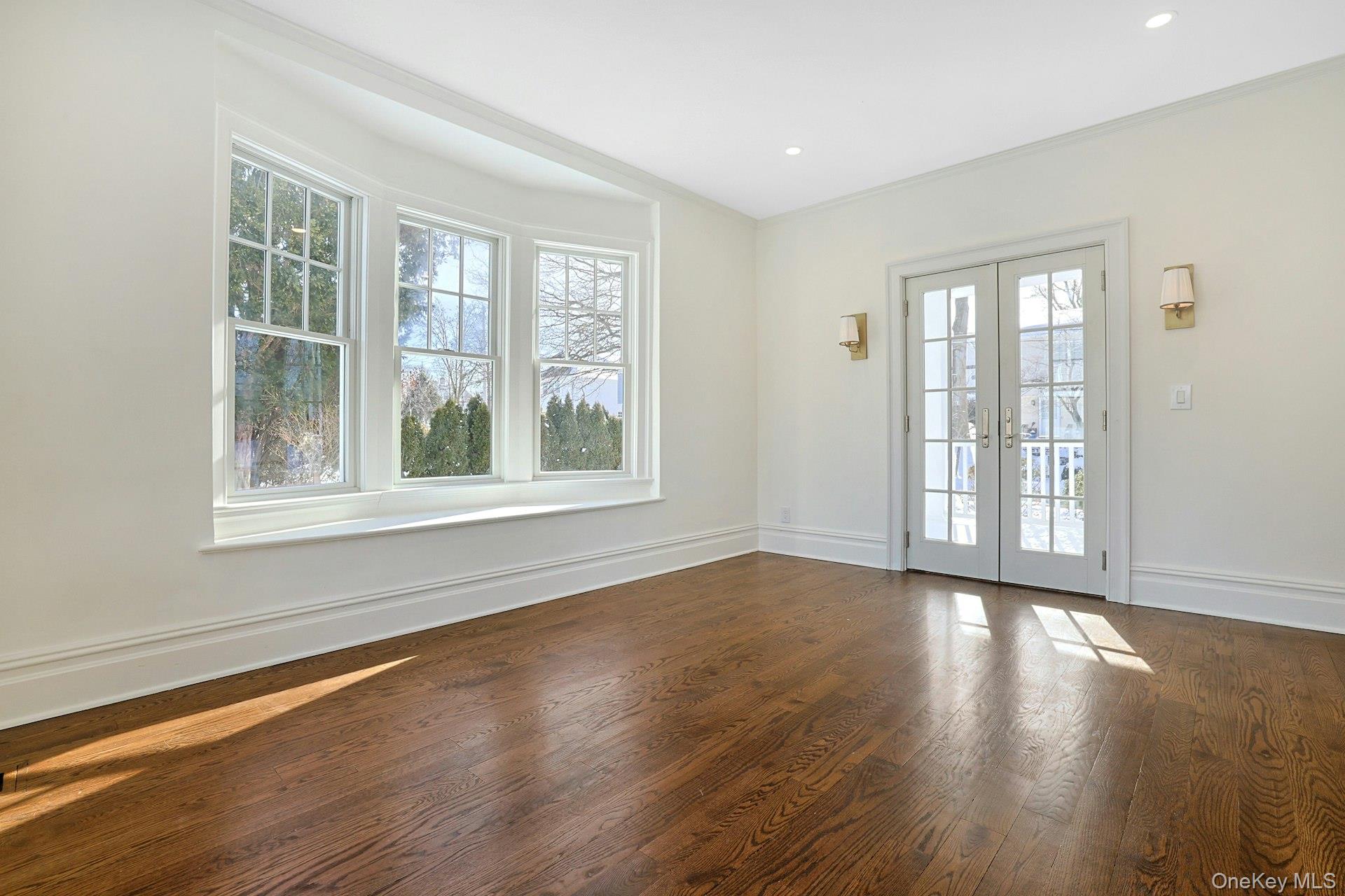 5 Henry Street Tuckahoe, NY 10707 - Photo 13 of 34 Sun-filled formal living room or den features French doors to the porch framed with elegant sconces and an inviting window seat.