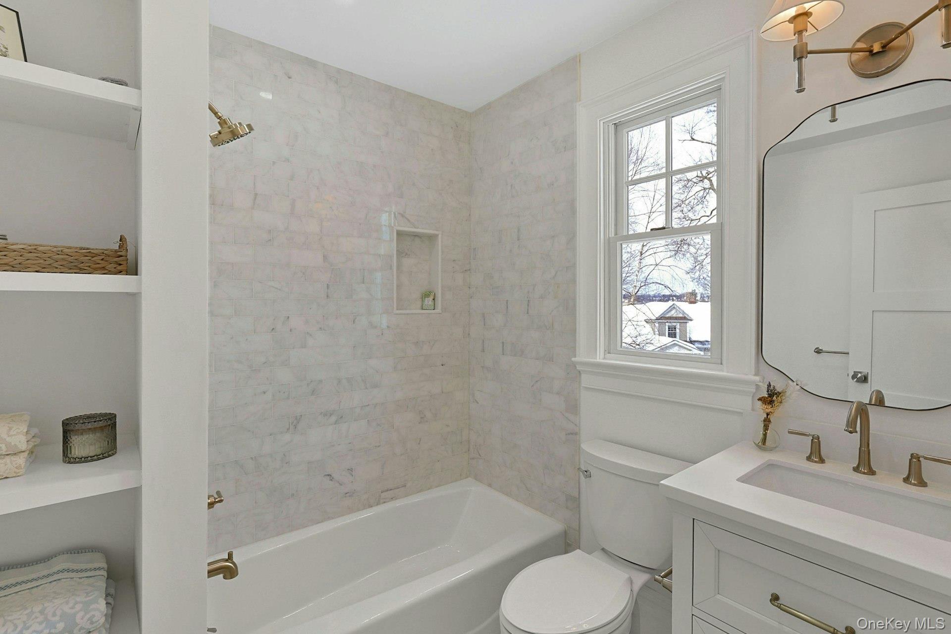 5 Henry Street Tuckahoe, NY 10707 - Photo 23 of 34 Hall bath has custom shelving with Kohler vanity and designer lighting.