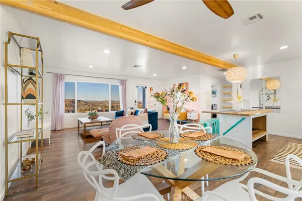 a living room with lots of furniture and kitchen view