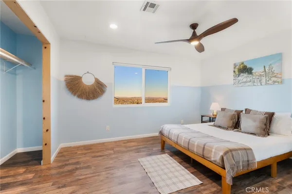 a bedroom with a large bed and a large window