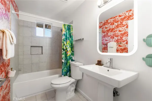 a bathroom with a sink mirror and toilet