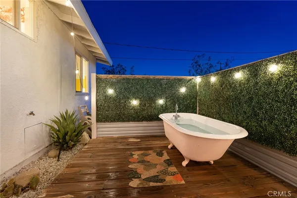 a view of a swimming pool with a patio and plants