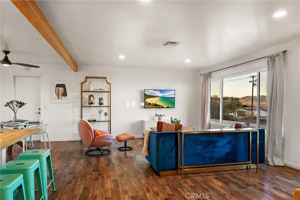 a view of a workspace with furniture and wooden floor