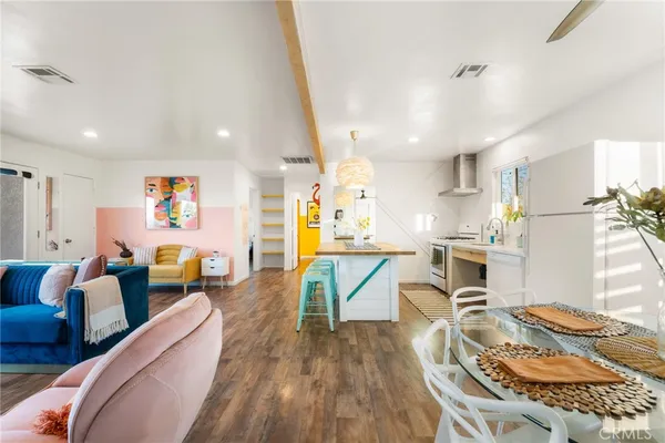 a living room with furniture and kitchen view