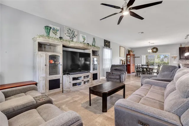 a kitchen with stainless steel appliances kitchen island granite countertop a stove a sink a oven a dining table with chairs and granite countertops