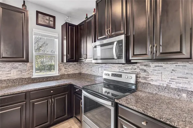 a spacious bathroom with a granite countertop sink mirror and double
