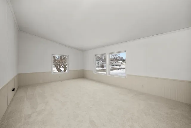 an empty room with a painting on the wall