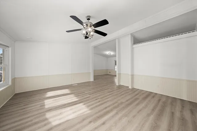 a view of an empty room and wooden floor