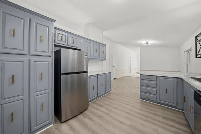 a kitchen with stainless steel appliances a refrigerator and cabinets