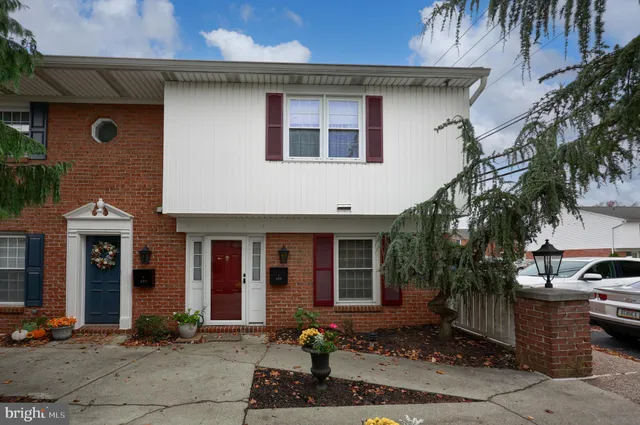 a front view of a house with parking area