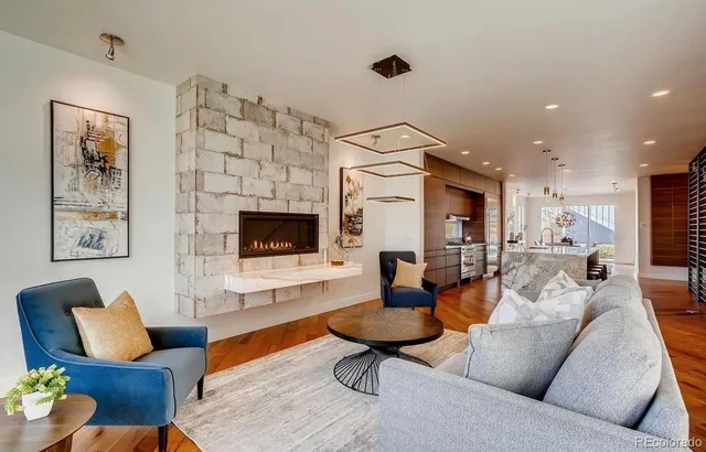 a living room with furniture kitchen view and a fireplace