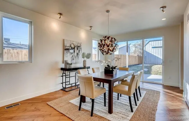 a view of a dining room with furniture window and wooden floor