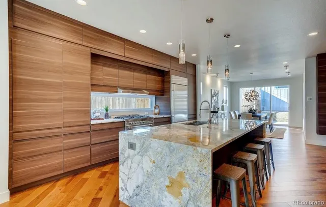 a kitchen with stainless steel appliances kitchen island granite countertop a sink and cabinets