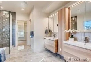 a bathroom with a tub sink and mirror