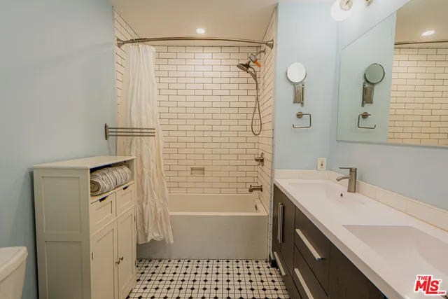 a bathroom with a sink a shower and a mirror