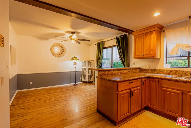 a living room with a sink and a refrigerator