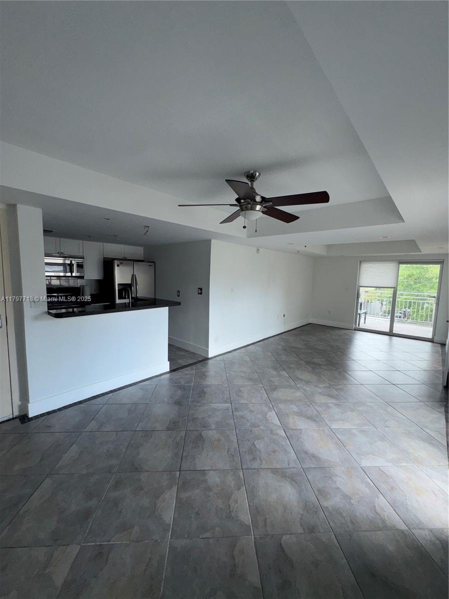 498 Southwest 2nd Street, Unit 2D Miami, FL 33130 - Photo 16 of 35 a view of a livingroom with wooden floor and a ceiling fan