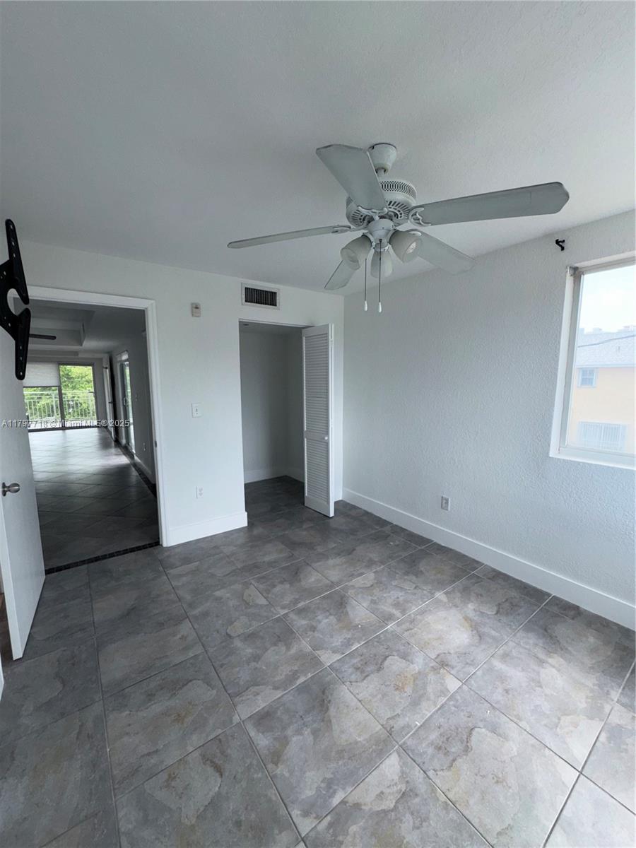 498 Southwest 2nd Street, Unit 2D Miami, FL 33130 - Photo 19 of 35 a view of a livingroom with a ceiling fan and window