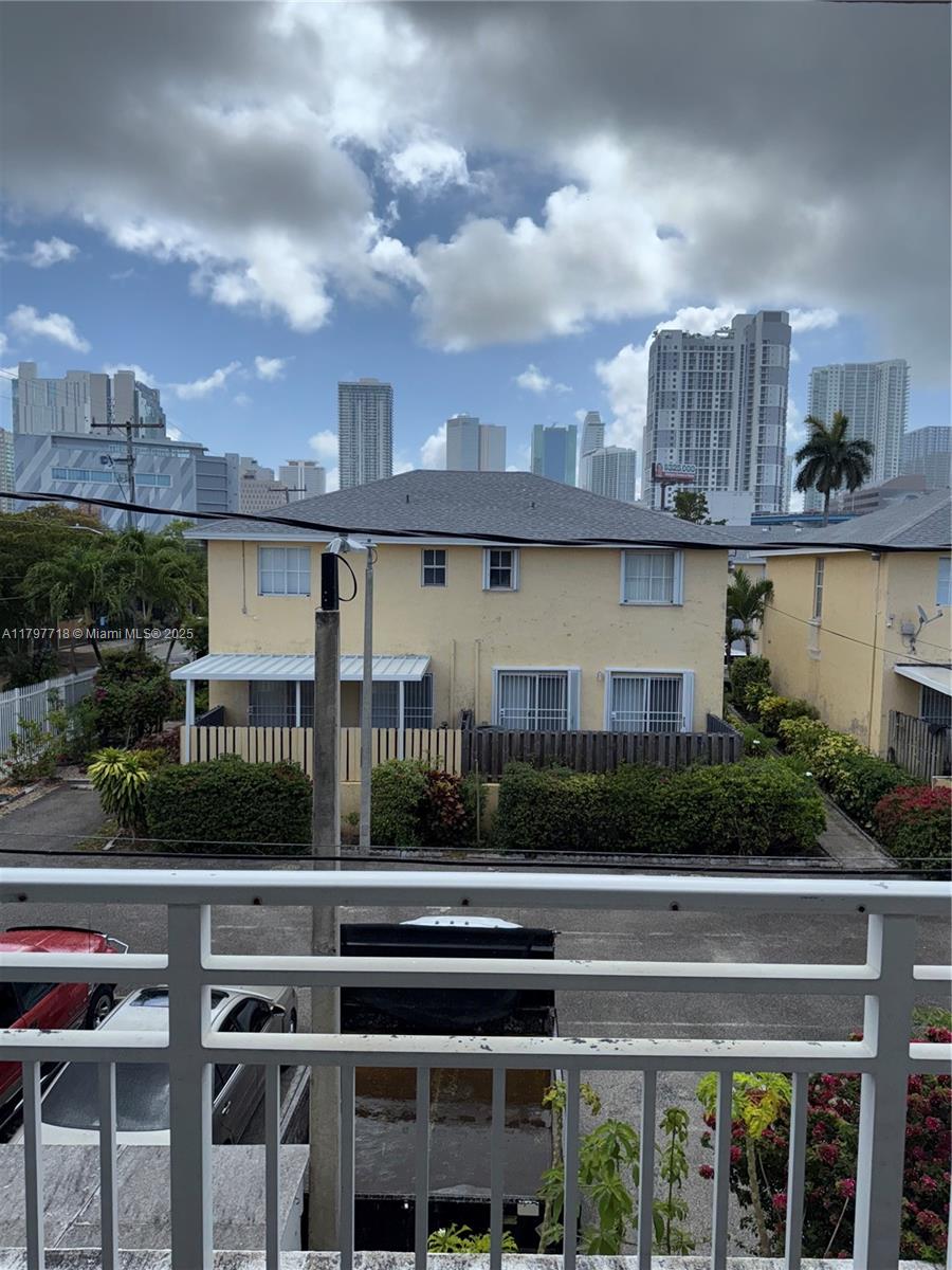498 Southwest 2nd Street, Unit 2D Miami, FL 33130 - Photo 22 of 35 a view of building with garden space and car parked