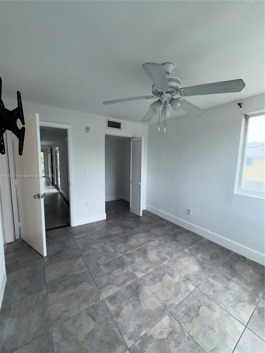 498 Southwest 2nd Street, Unit 2D Miami, FL 33130 - Photo 28 of 35 a view of a livingroom with a ceiling fan and window