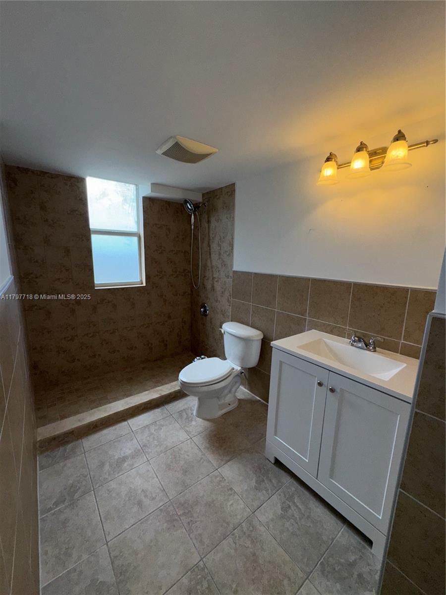 498 Southwest 2nd Street, Unit 2D Miami, FL 33130 - Photo 29 of 35 a bathroom with a sink a toilet and shower