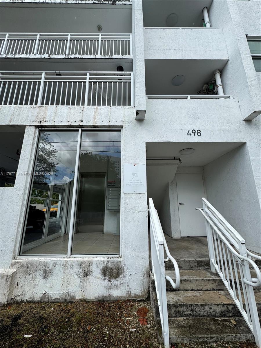 498 Southwest 2nd Street, Unit 2D Miami, FL 33130 - Photo 33 of 35 a view of a livingroom with furniture and staircase