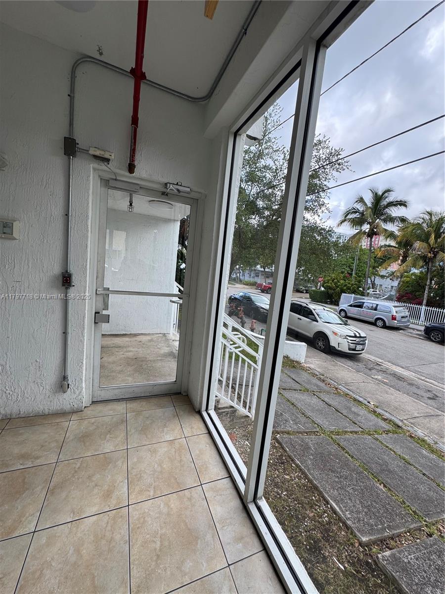 498 Southwest 2nd Street, Unit 2D Miami, FL 33130 - Photo 4 of 35 a view of a car garage door and porch