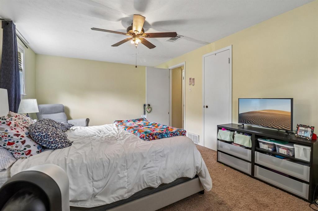 820 North Bowen Road Arlington, TX 76012 - Photo 30 of 40 a bedroom with a bed and a flat screen tv