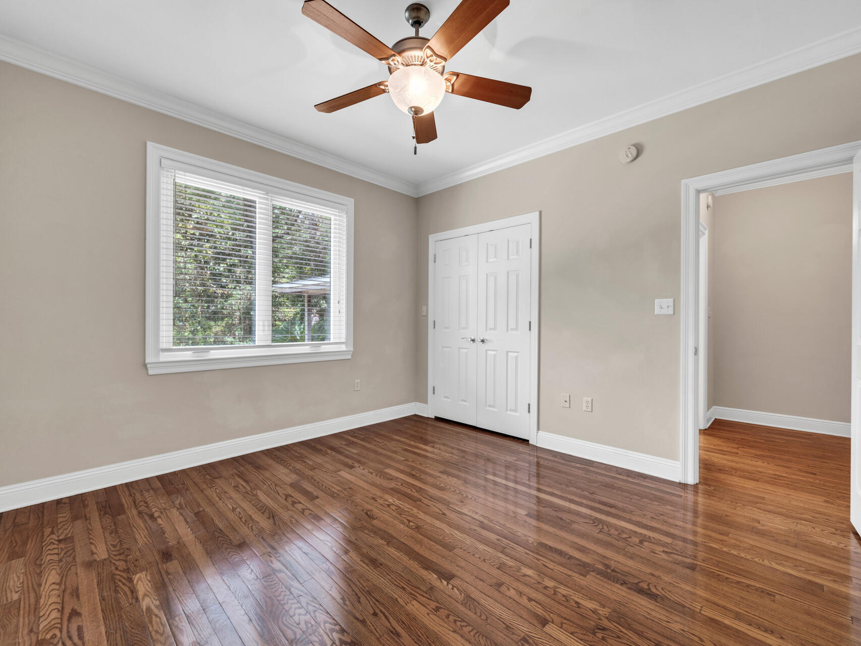 145 Mulry Drive Niceville, FL 32578 - Photo 39 of 58 an empty room with wooden floor ceiling fan and windows