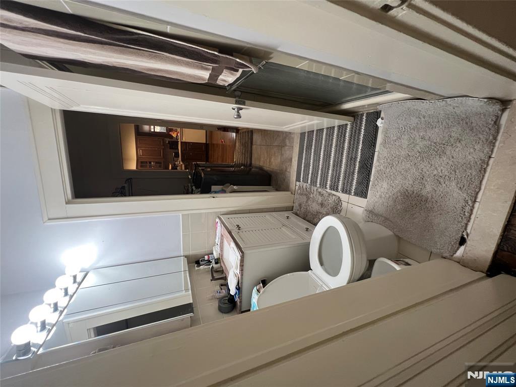 26 Wayne Street Montvale, NJ 07645 - Photo 19 of 32 a bathroom with a toilet sink and mirror