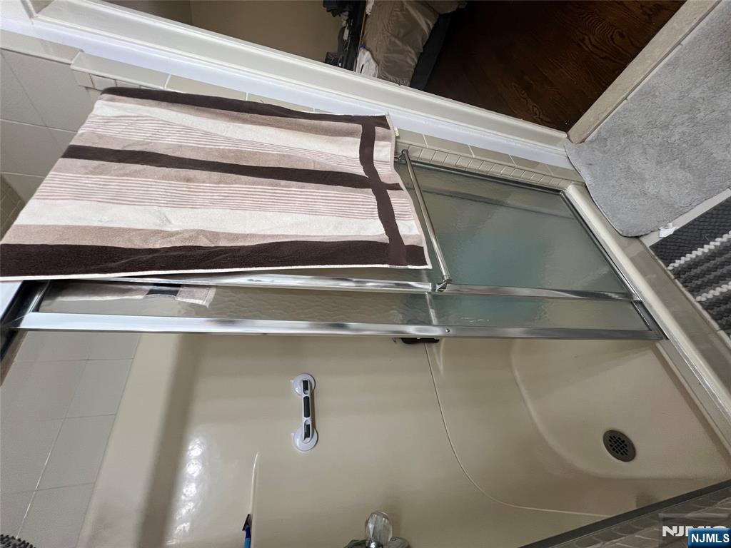 26 Wayne Street Montvale, NJ 07645 - Photo 20 of 32 a bathroom with a shower and a tub