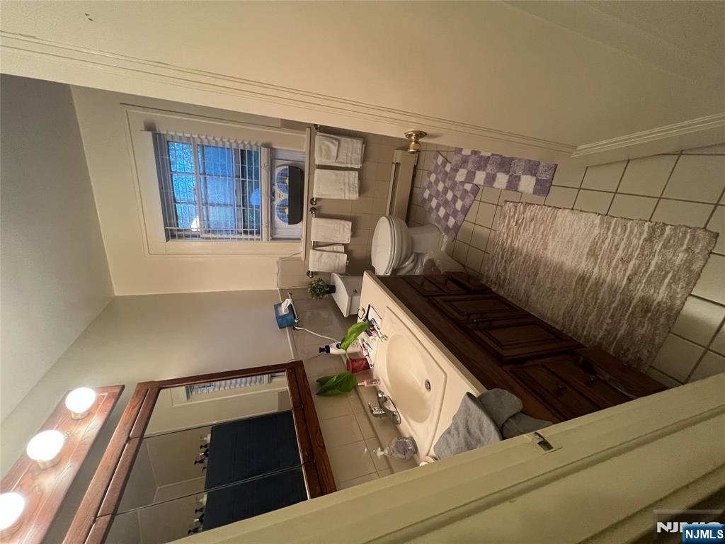 26 Wayne Street Montvale, NJ 07645 - Photo 28 of 32 a bathroom with a sink a mirror and a toilet