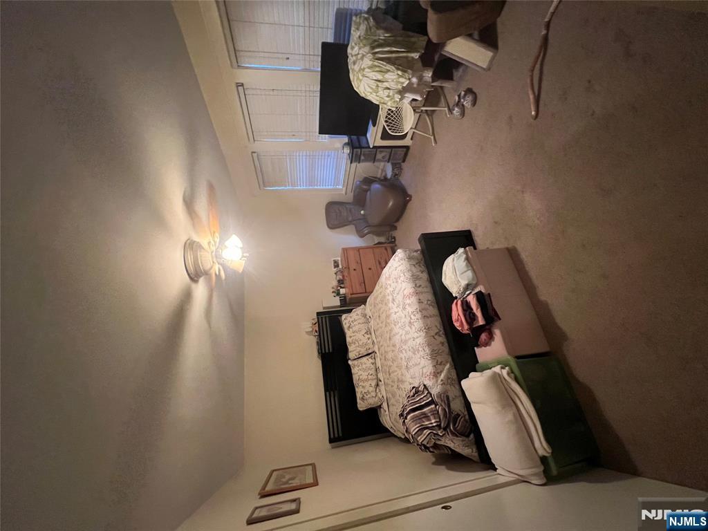 26 Wayne Street Montvale, NJ 07645 - Photo 30 of 32 a bed room with furniture and a ceiling fan