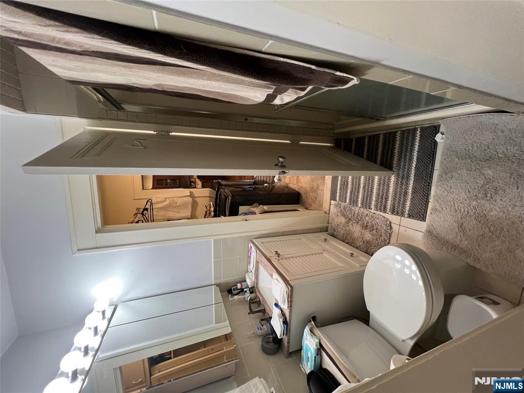 26 Wayne Street Montvale, NJ 07645 - Photo 7 of 32 a bathroom with a sink a toilet a mirror and shower view