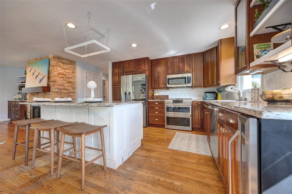105 Riverside Drive Ormond Beach, FL 32176 - Photo 17 of 100 a kitchen with stainless steel appliances granite countertop a table chairs sink and cabinets