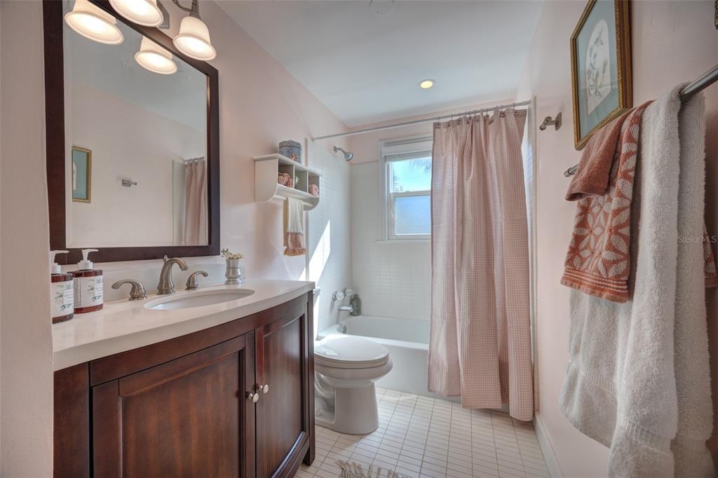 105 Riverside Drive Ormond Beach, FL 32176 - Photo 21 of 100 a bathroom with a granite countertop sink toilet a mirror a vanity and shower