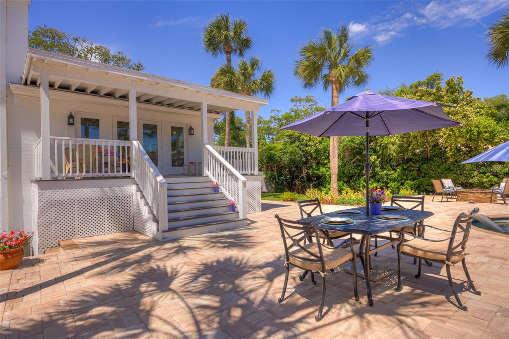 105 Riverside Drive Ormond Beach, FL 32176 - Photo 33 of 100 a view of a patio with a table and chairs under an umbrella
