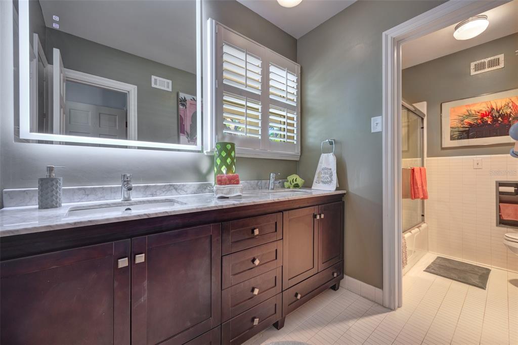 105 Riverside Drive Ormond Beach, FL 32176 - Photo 46 of 100 a bathroom with a granite countertop sink double vanity and a mirror
