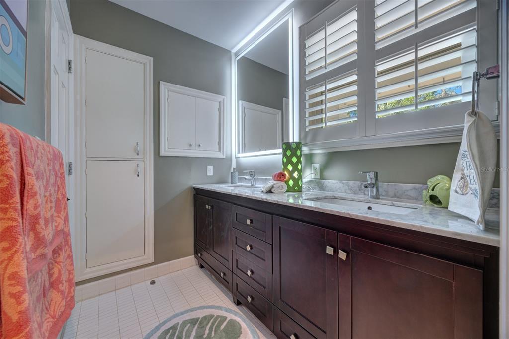 105 Riverside Drive Ormond Beach, FL 32176 - Photo 49 of 100 a bathroom with a granite countertop sink a mirror and a shower