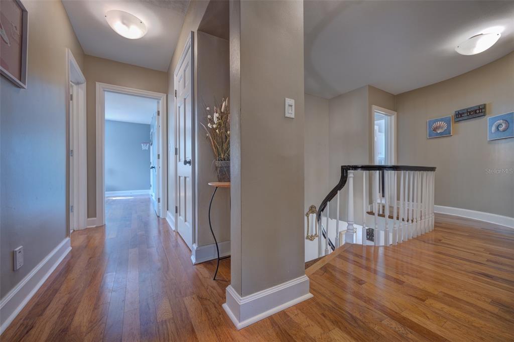 105 Riverside Drive Ormond Beach, FL 32176 - Photo 50 of 100 a view of a hallway with wooden floor and stairs