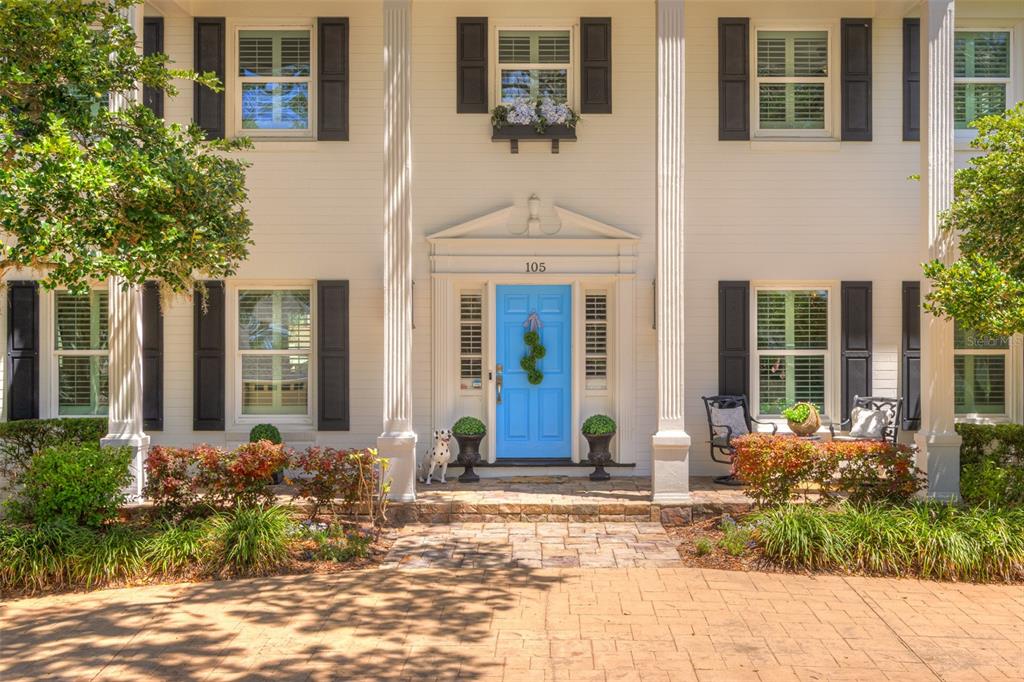 105 Riverside Drive Ormond Beach, FL 32176 - Photo 5 of 100 front view of a brick house with potted plants