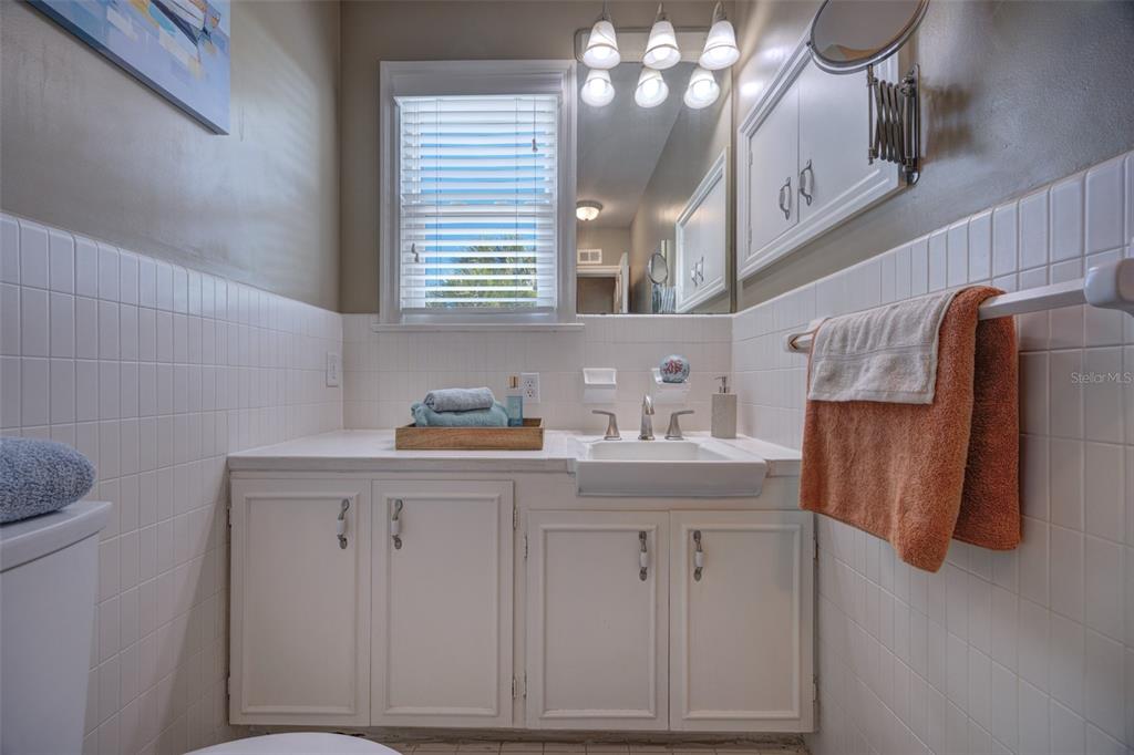 105 Riverside Drive Ormond Beach, FL 32176 - Photo 54 of 100 a bathroom with a sink and a mirror