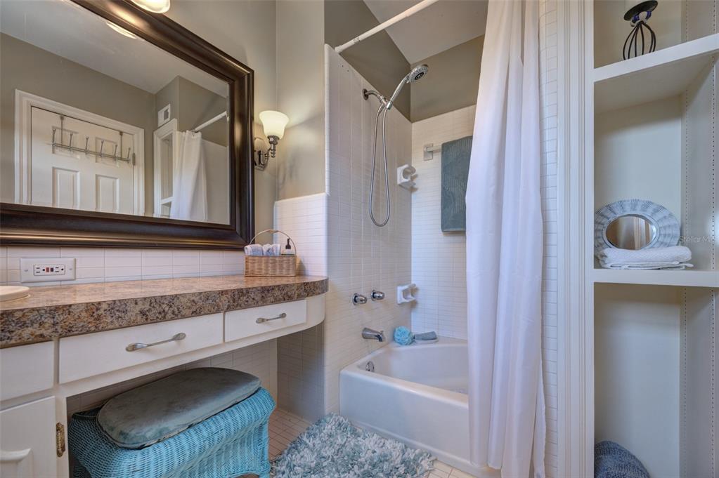 105 Riverside Drive Ormond Beach, FL 32176 - Photo 60 of 100 a bathroom with a granite countertop sink a mirror and a bathtub
